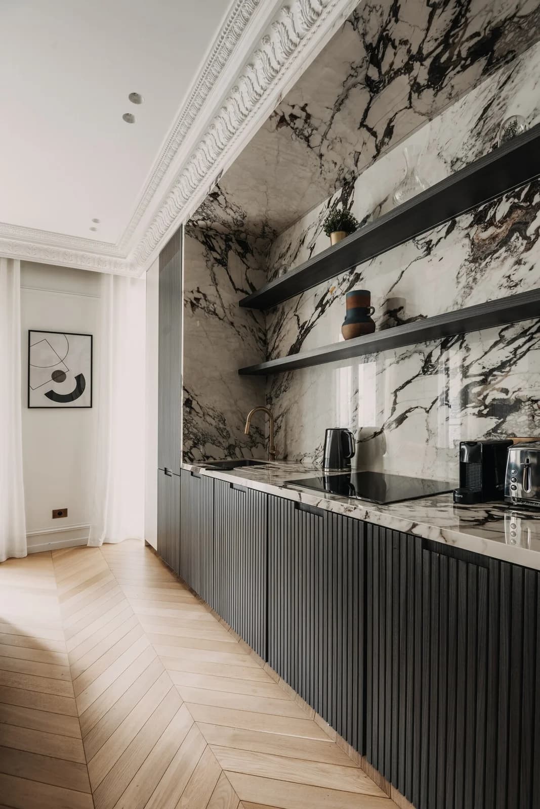 Calacatta viola kitchen with fluted black cabinetry and brass tap
