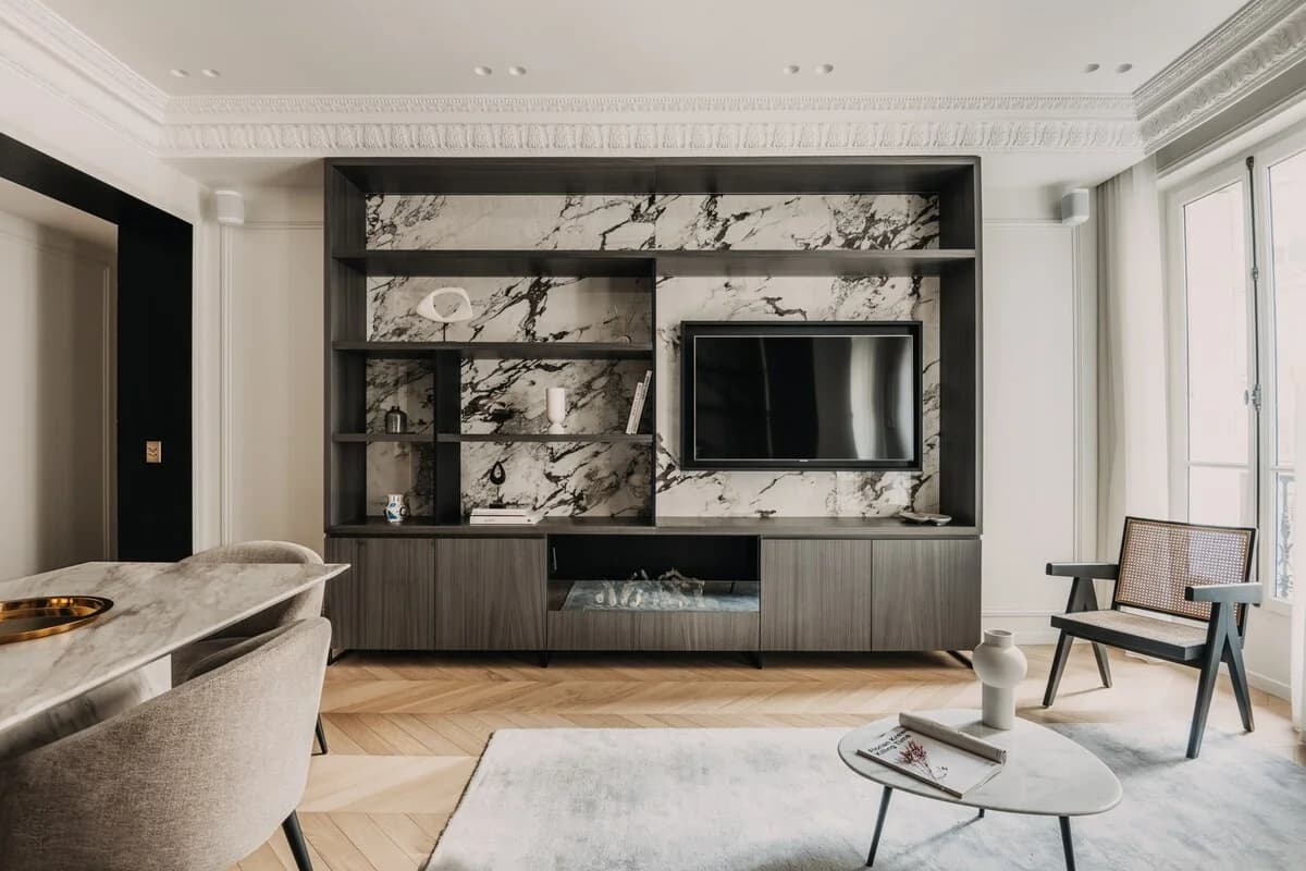 Marble media wall with elaborate cornice and herringbone floor