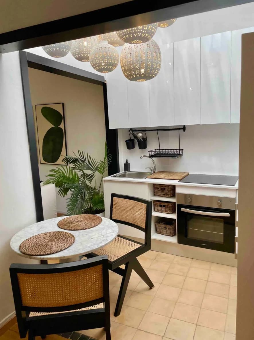 Skylit kitchen-diner with cluster of woven globe pendants