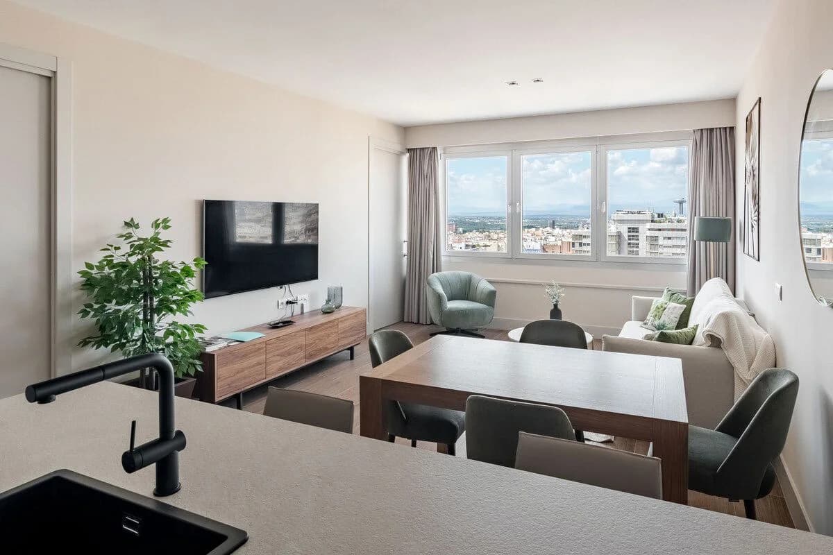 Sun-filled open-plan living and dining with sweeping Madrid skyline view