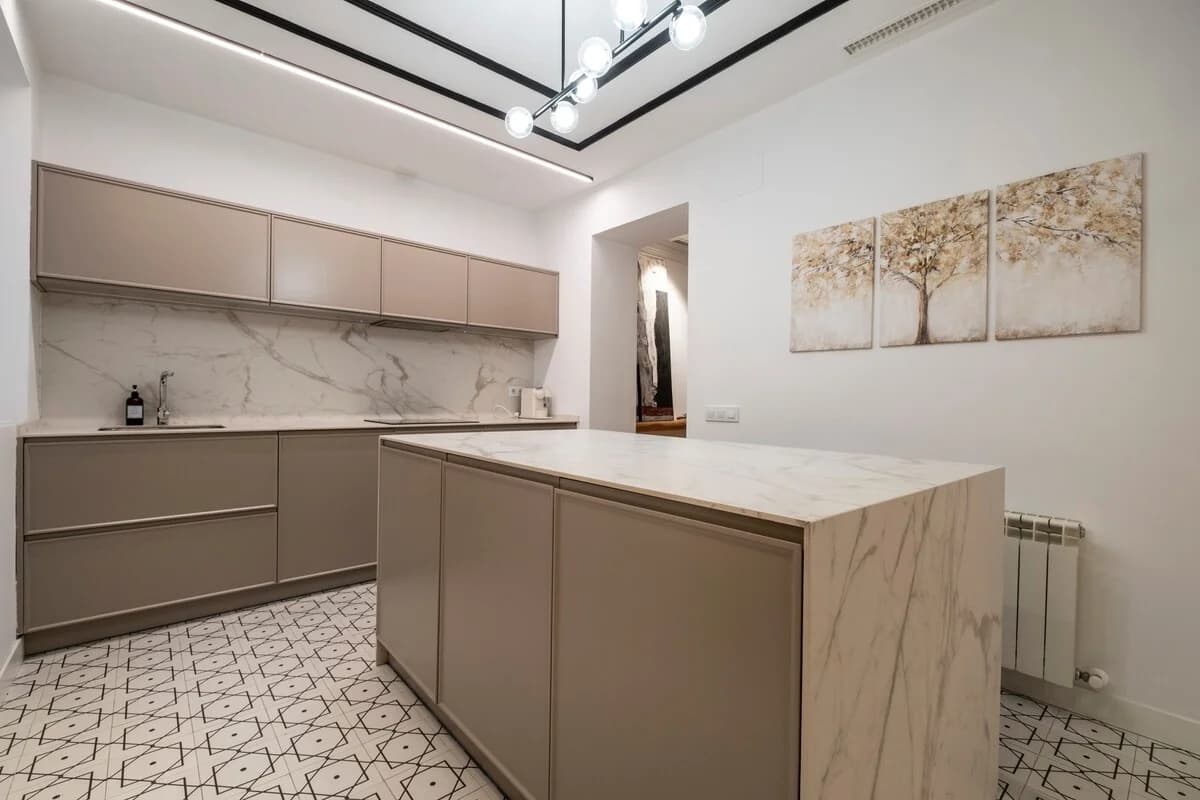 Marble splashback kitchen with patterned floor and tonal cabinetry