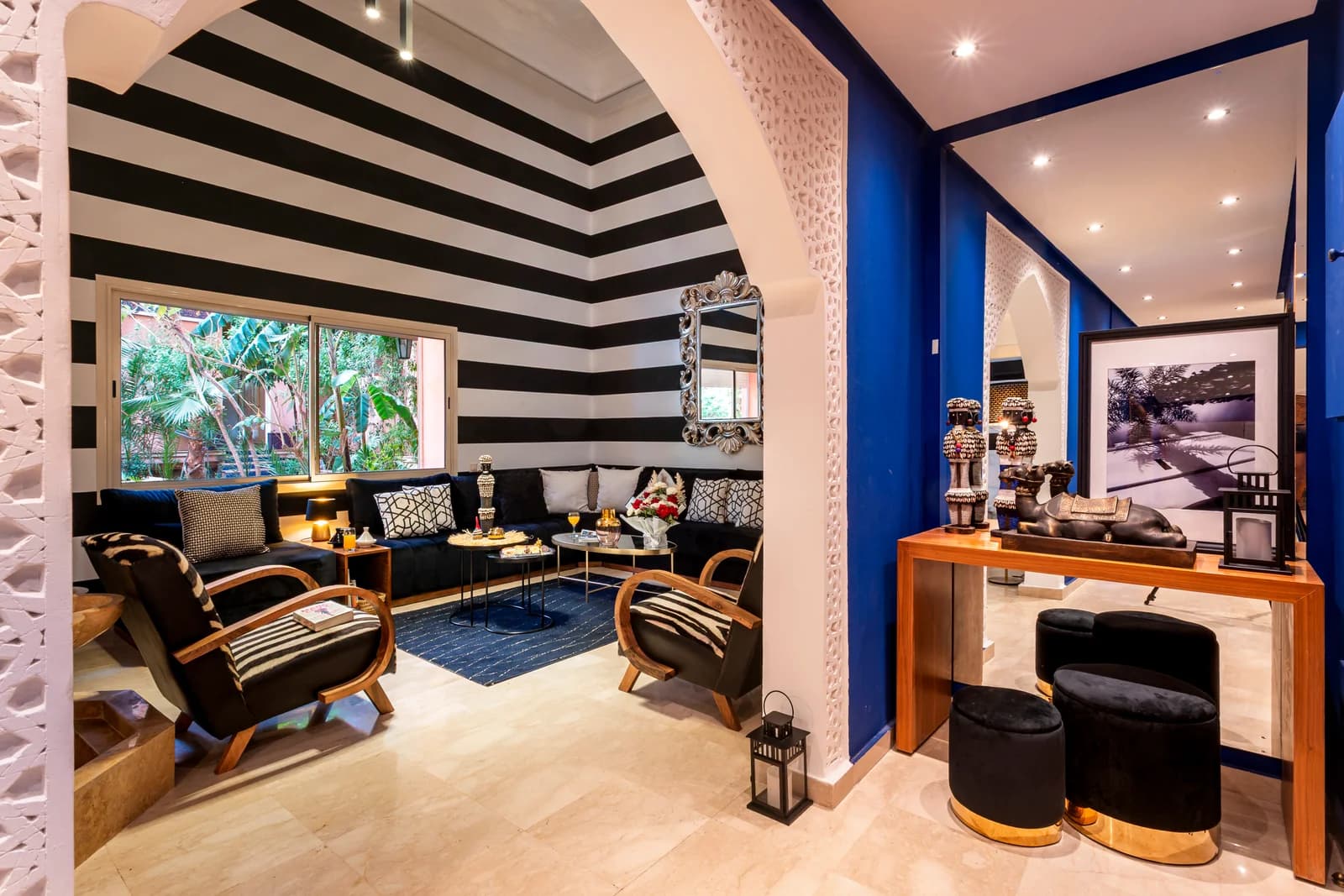 Arched threshold linking blue corridor and striped lounge